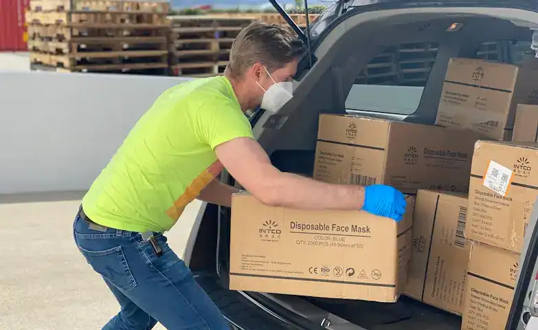 Delivery of boxes containing disposable face masks being unloaded from a vehicle at Trinity Accounting Practice, an Australian firm based in Beverly Hills, NSW.