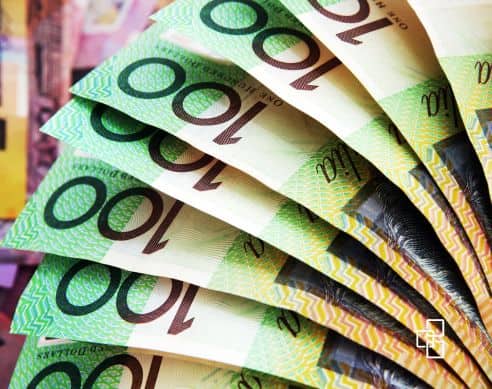 Close-up of multiple Australian $100 banknotes fanned out, symbolising wealth, savings, and financial growth opportunities.