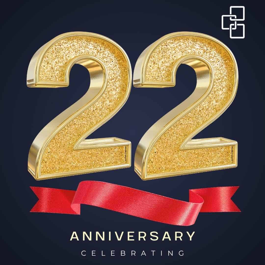 Gold glitter number 22 candles with a red ribbon on a dark background, symbolising a 22nd anniversary celebration for a professional accounting firm in Beverly Hills, NSW.