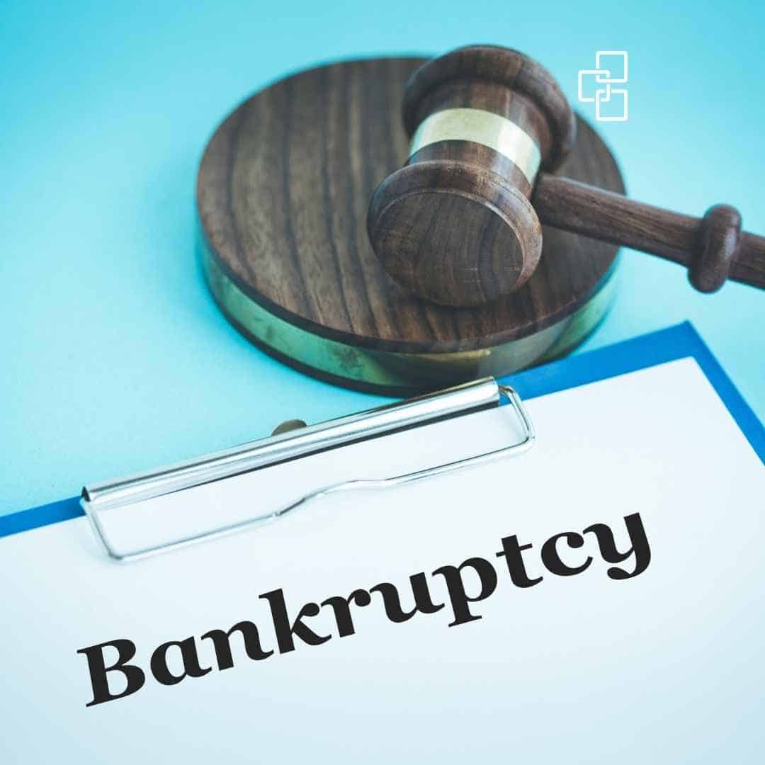 Gavel resting on a wooden sound block next to a document with the word "Bankruptcy" in bold letters, symbolising legal and financial proceedings related to insolvency.
