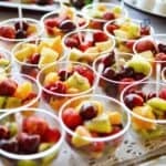 Home Based Business Success in Australia Fresh fruit cups with a variety of colorful fruits including grapes, melons, and kiwi, served in small clear plastic cups, perfect for a healthy snack or event.
