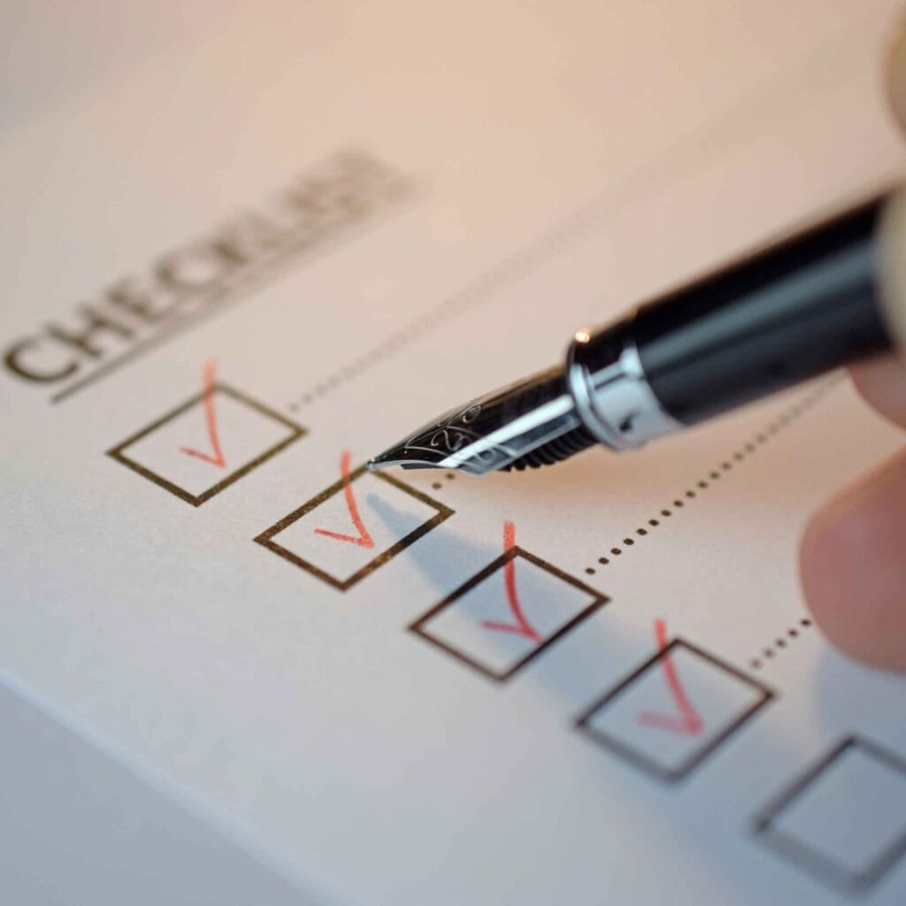 Professional tax checklist with marked items, pen, and checkboxes for financial review.