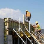 The Ultimate Guide to Construction Accounting in Sydney construction workers installing concrete formwork on commercial construction site in australia