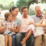Family enjoying outdoor time together in a lush garden, sharing smiles and laughter on a sunny day.