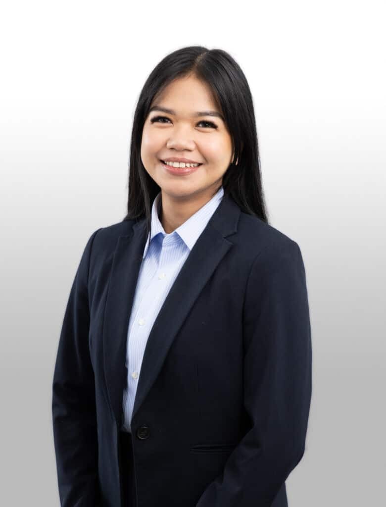 Professional Asian woman in business suit smiling, representing Trinity Accounting Practice in Beverly Hills, NSW.