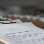 Clipboard with documents on a desk, representing a business due diligence checklist