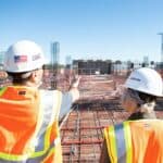 Construction workers in hard hats on a building site, representing accountants for construction businesses in Sydney