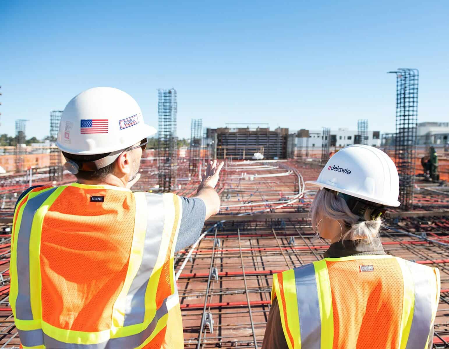 Construction workers in hard hats on a building site, representing accountants for construction businesses in Sydney