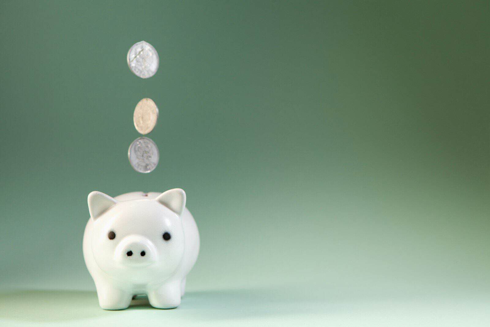 Piggy bank with a coin, representing setting up a self-managed super fund (SMSF) in Australia