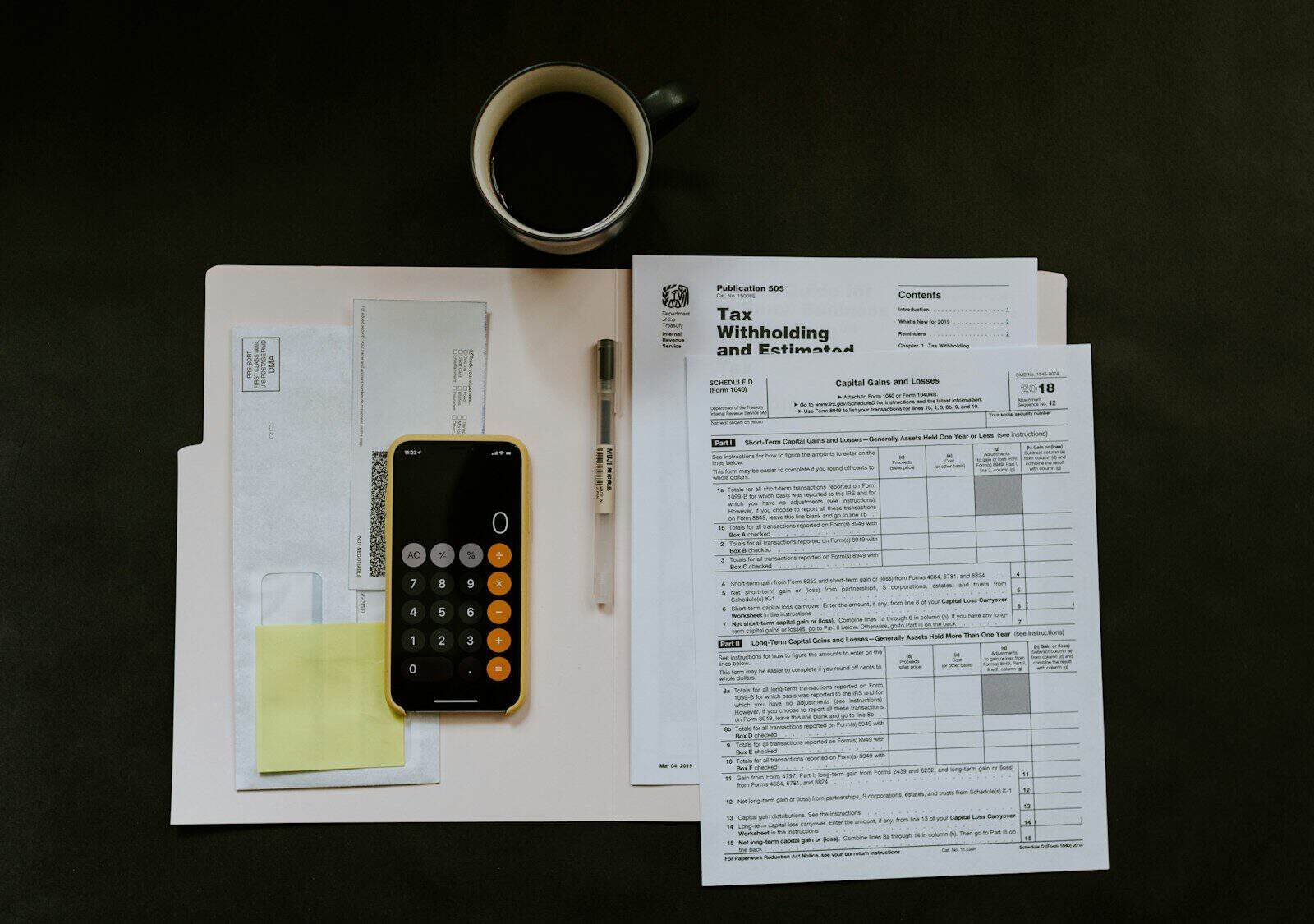 Tax invoices, paperwork and a calculator on a desk, representing GST input tax credits