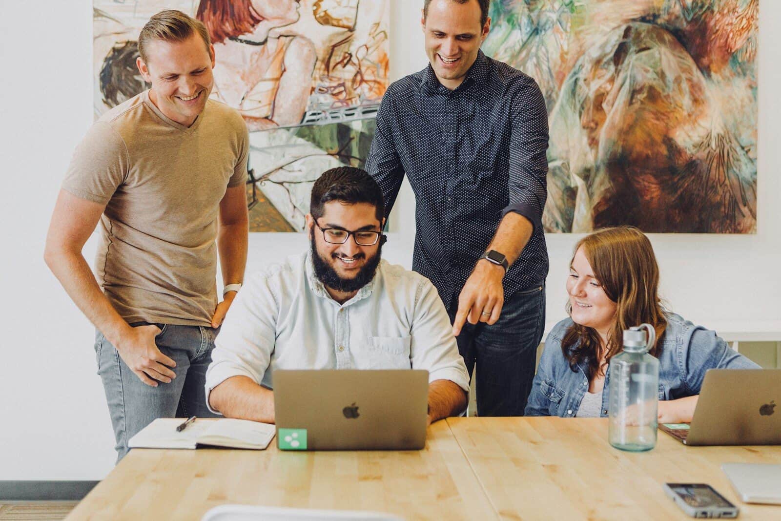 Startup founders reviewing figures on a laptop in an office, representing startup accountants in Australia