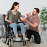 Support worker assisting a person using a wheelchair, representing NDIS accountants for disability providers in Sydney